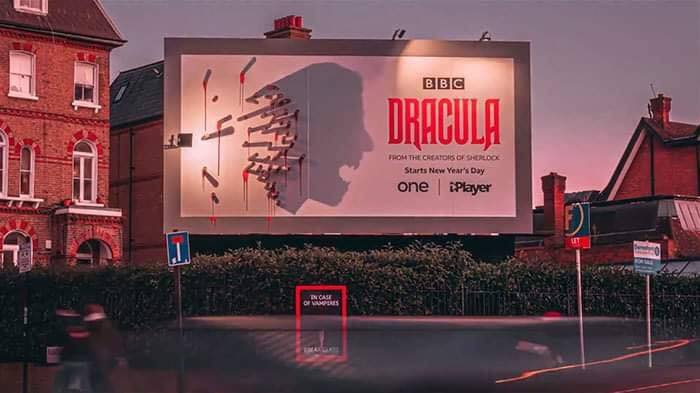 An Out of Home advertisement for the BBC show Dracula. As the sun sets, a light placed on the billboard shinees and the resulting shadow from the stakes begins to depict Dracula's head in the shadow cast.